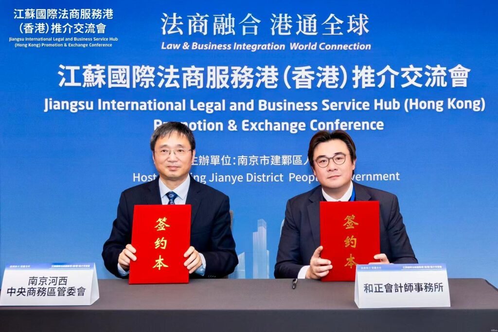 Image of two officials sitting at the press
